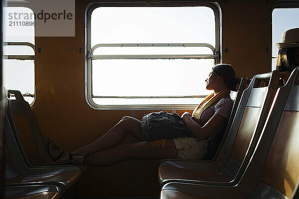 Woman with backpack relaxing in train