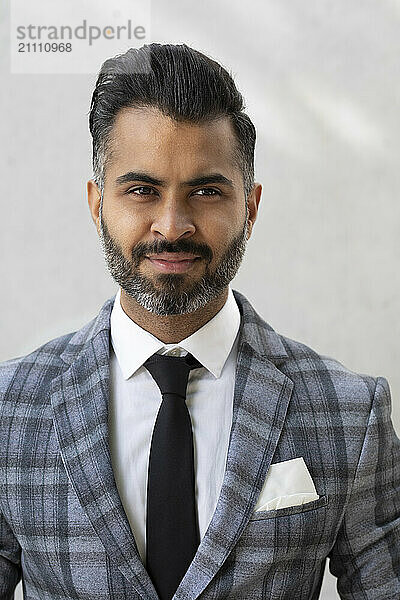 Smiling businessman against white background