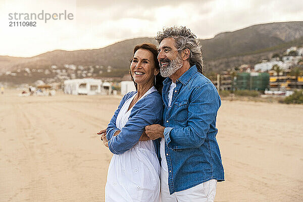 Heterosexual couple enjoy spending leisure time at beach