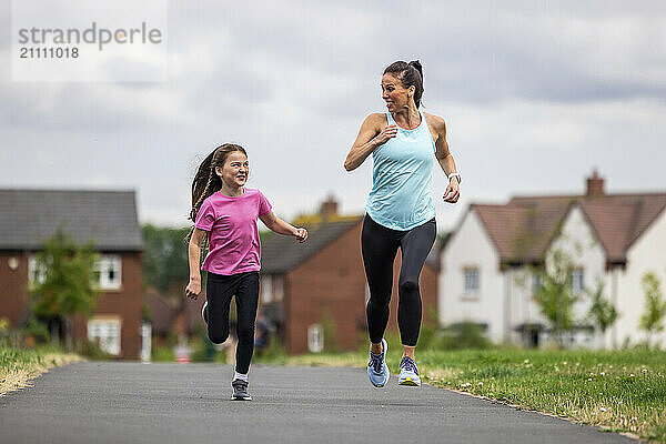 Mother and daughter competing each other in running