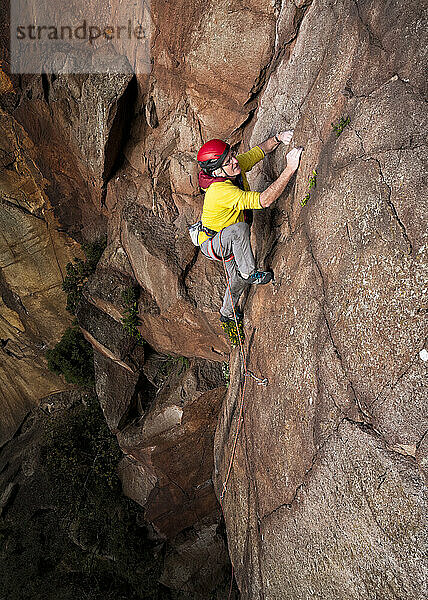 Carefree man climbing North Berwick Law in Scotland