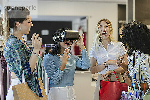 Woman wearing virtual reality headset with friends shopping at store