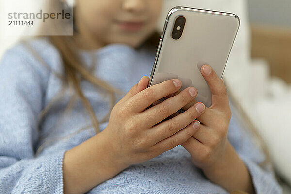 Girl using smart phone at home