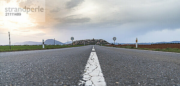 Asphalt road with dividing line under blue sky