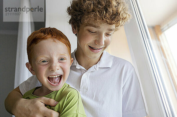 Cute boy with brother at home