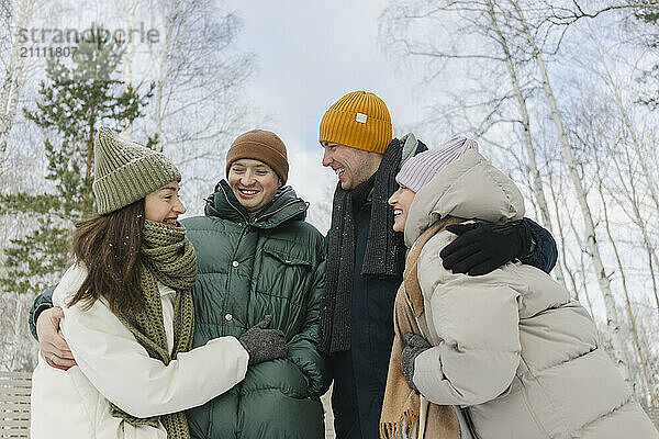 Happy friends having fun with each other in winter