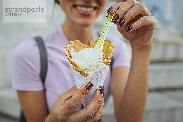 Smiling woman holding ice cream cone