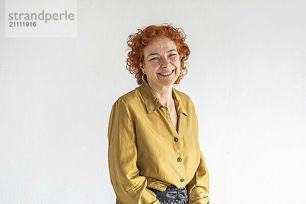 Happy redhead woman against white background