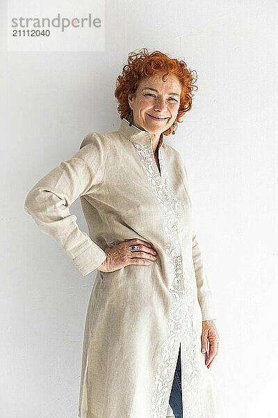 Smiling woman standing against white background