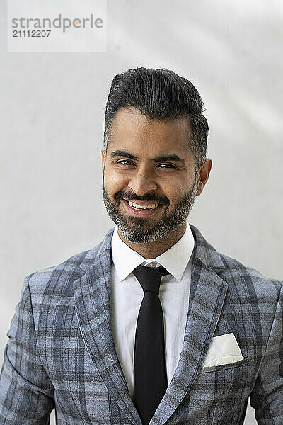 Happy businessman against white background