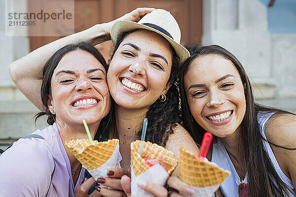 Cheerful female friends with ice cream cones