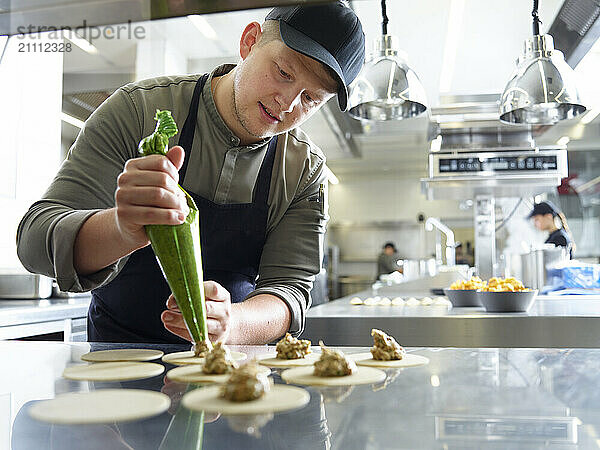 Chef filling dumplings in kitchen at restaurant