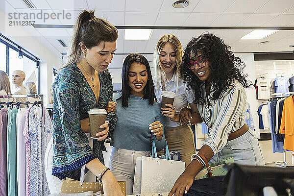 Diverse multiracial friends shopping together at fashion store