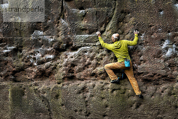 Climber climbing Pex Hill in England