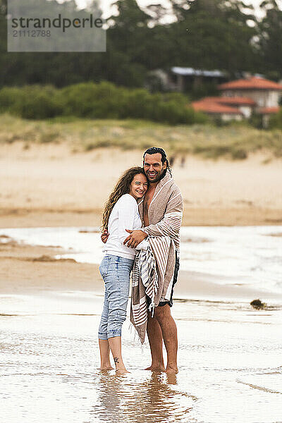 Happy couple embracing at beach