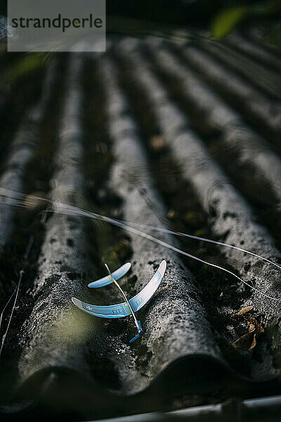 Toy airplane on corrugated rooftop