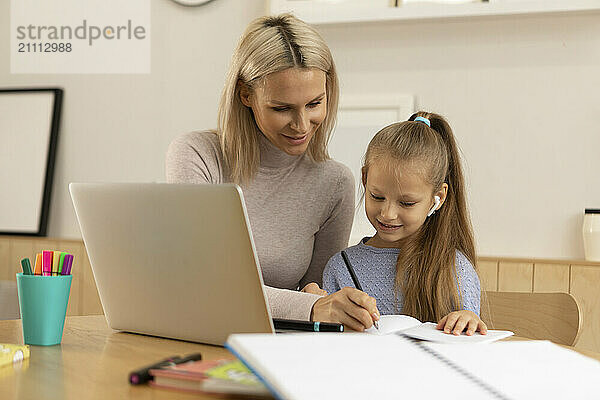 Mother guiding daughter at home