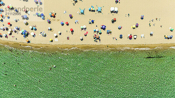 Aerial view of beach with colorful umbrellas in Italy