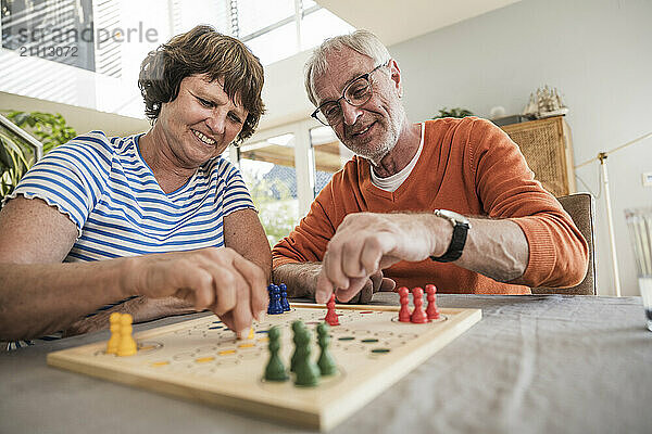 Senior couple playing ludo at home