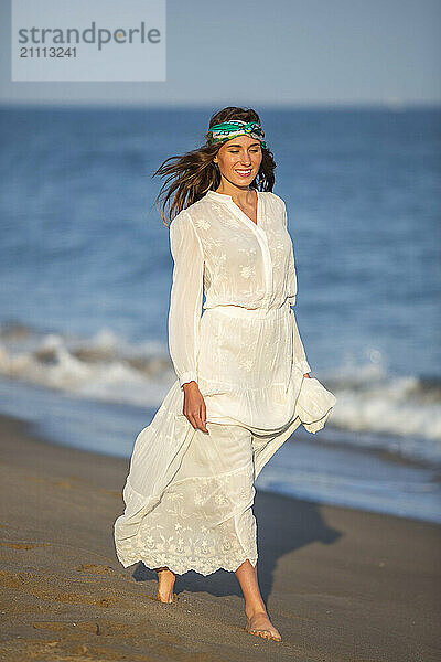 Beautiful woman walking near seashore