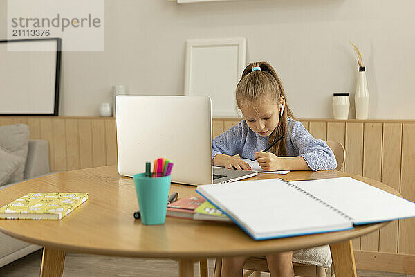 Girl sitting and studying at home