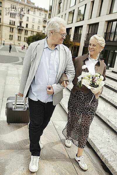 Happy couple walking on street