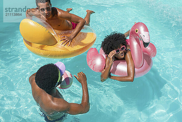 Smiling woman enjoying with friends in pool