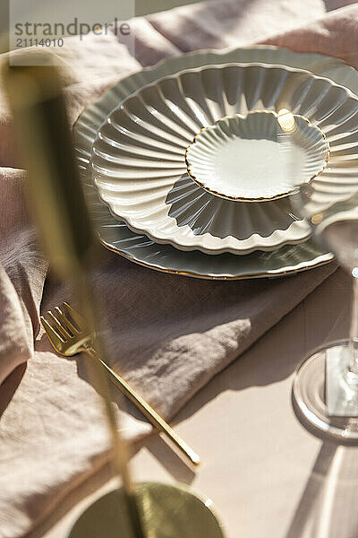 Crockery and cutlery arranged on table