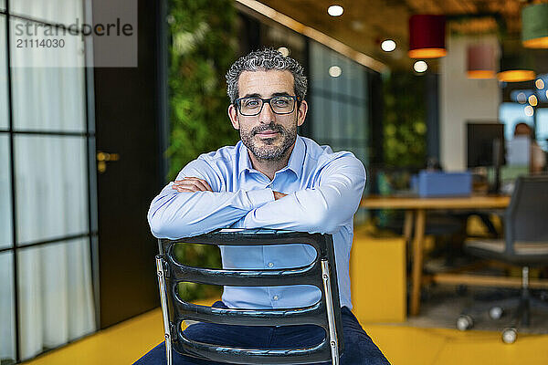 Businessman sitting on chair and relaxing at co working space