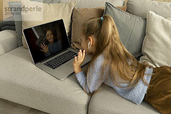 Girl gesturing on video call at home