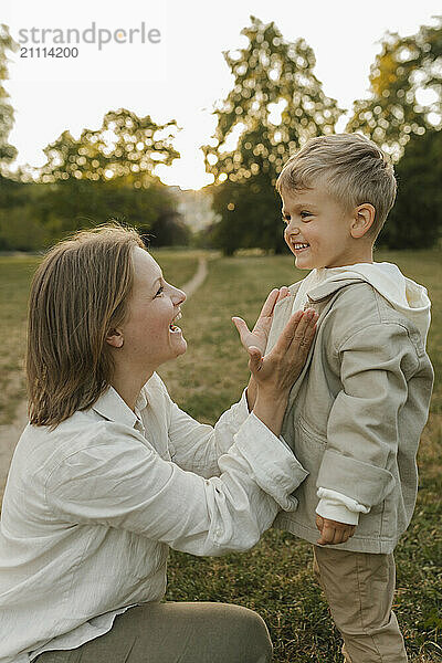 Happy mother spending leisure time with son at park