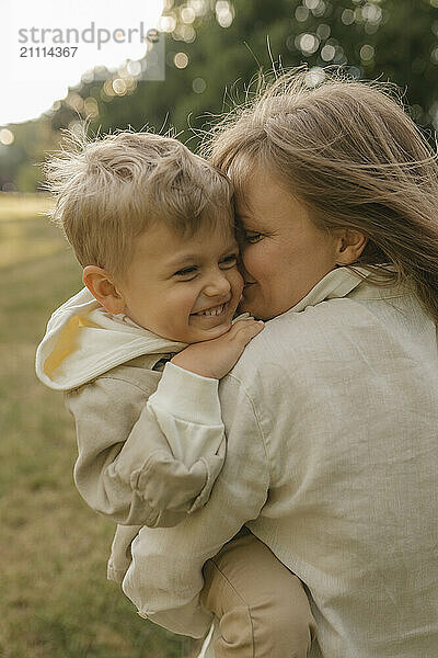 Mother embracing son at park