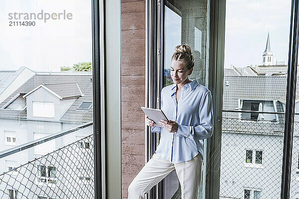 Businesswoman using tablet PC in office