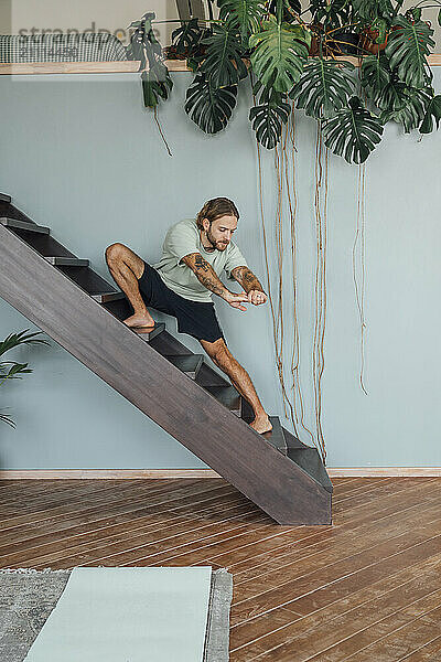 Man exercising on staircase at home