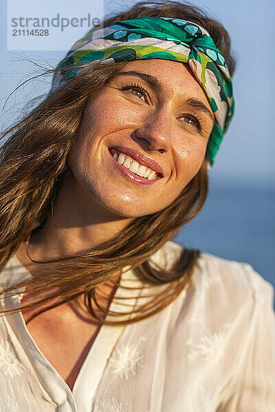 Happy young woman wearing bandana