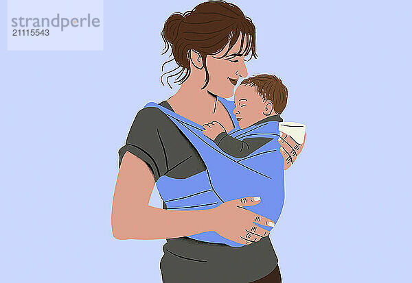 A smiling woman lovingly holds a sleeping baby in a blue sling while holding a small cup in her hand.