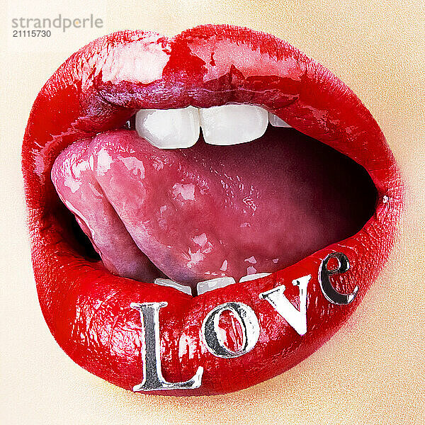 Close-up of red lips with the word LOVE painted on them  sticking out a tongue.