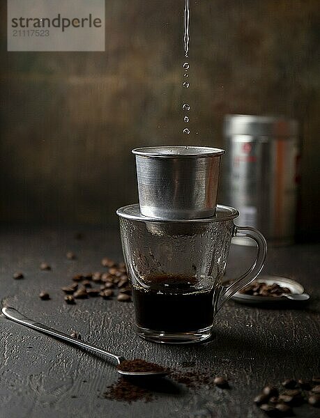 Zubereitung von vietnamesischem Kaffee mit Aluminium Kaffeefilter auf dunklem Hintergrund