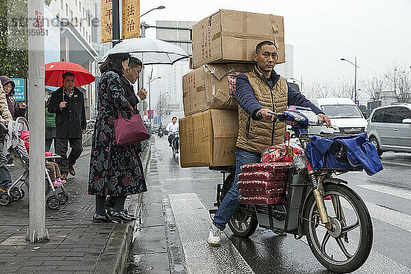 Man on Motorcycle Overloaded with Goods  Shanghai  China