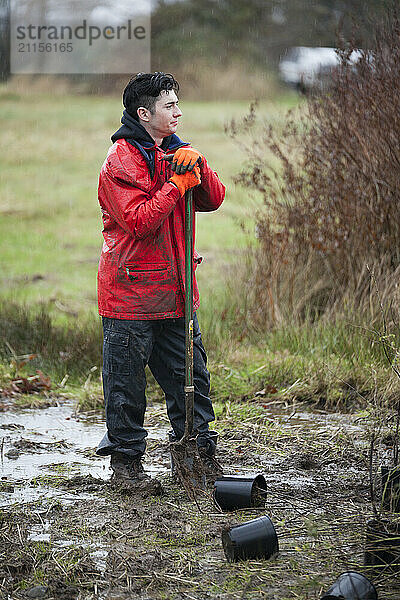 Volunteers restore parkland by planting native plants.