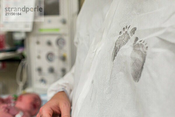 Newborn Baby Footprints in Ink on Dad's Hospital Gown