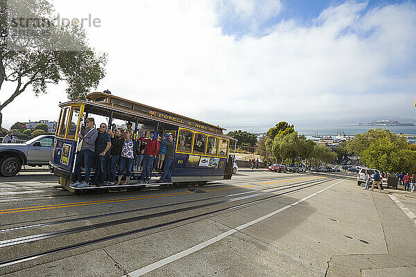 People riding cable car on street  San Francisco  California  USA