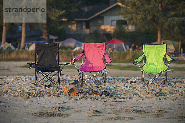 Three beach chairs on sand