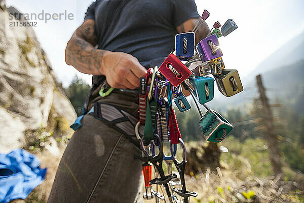 Climber holding climbing nuts while preparing for rock climbing