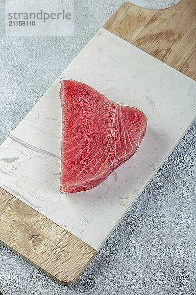 Food  Raw tuna steak on white concrete background