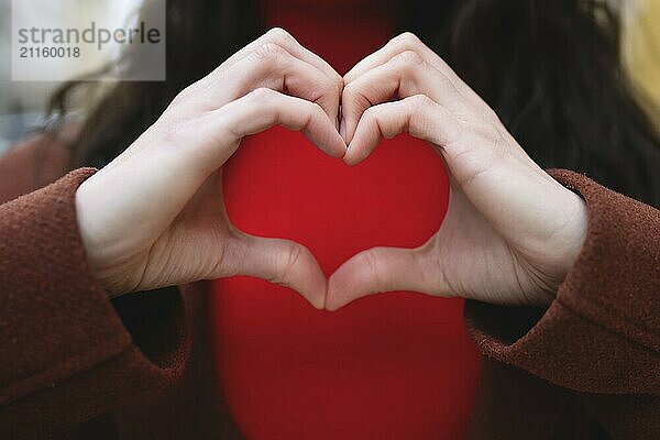 A close-up of a woman making a gesture of love. Valentines day