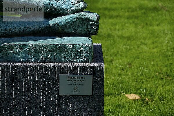 Feet of the Lying poet statue with inscription sign  Bergen  Vestland  Norway  Europe