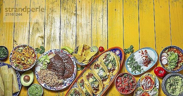 Food  Food  Mexican festive food for independence day  independencia chiles en nogada  tacos al pastor  chalupas pozole  tamales  chicken with mole poblano sauce. Yellow background