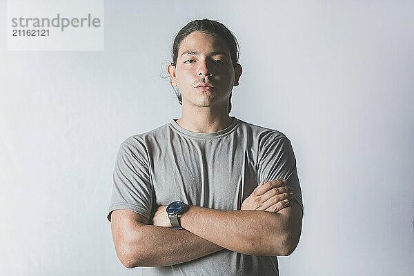 Portrait of handsome latin guy with crossed arms on isolated background