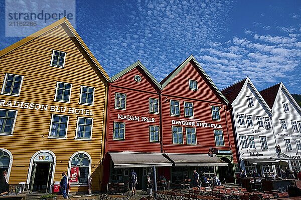 Traditional wooden houses under a blue sky with pitched roofs and multiple windows in a sunny old town  Bryggen  Bergen  Vestland  Norway  Europe